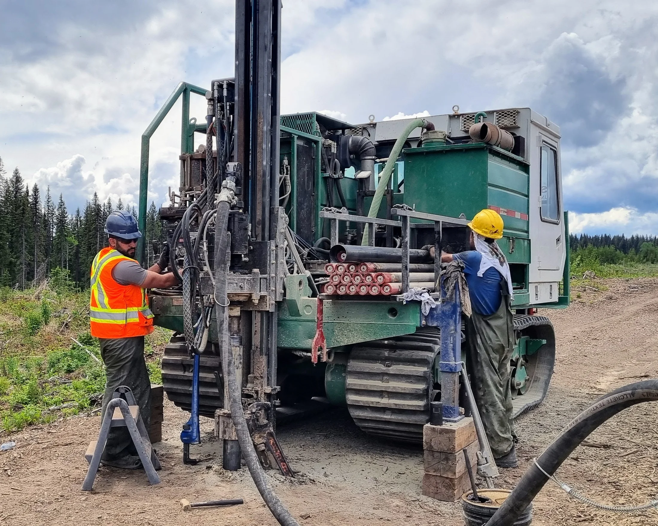 Placer exploration crew working with a drill in northern terrain